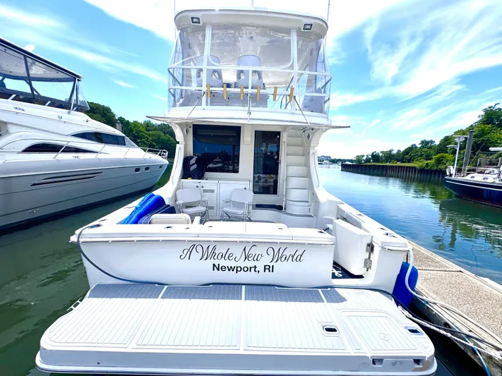 A Whole New World Yacht Photos Pics 2006 Silverton 50 Convertible yacht docked in Newport, RI, under a clear blue sky.