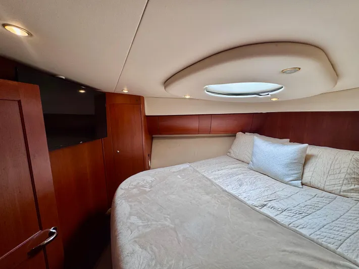 A Whole New World Yacht Photos Pics Luxurious bedroom interior of 2006 Silverton 50 Convertible yacht with cozy bedding.