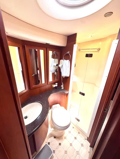 A Whole New World Yacht Photos Pics Luxurious bathroom in 2006 Silverton 50 Convertible yacht with modern fixtures and elegant design.