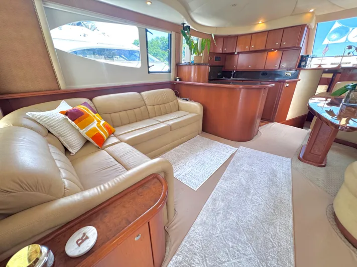 A Whole New World Yacht Photos Pics Luxurious interior of 2006 Silverton 50 Convertible yacht with plush seating and elegant wood finishes.
