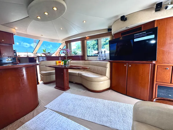 A Whole New World Yacht Photos Pics Luxurious interior of a 2006 Silverton 50 Convertible yacht with elegant seating and modern amenities.