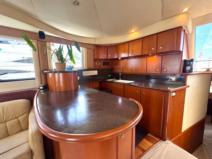 A Whole New World Yacht Photos Pics Luxurious 2006 Silverton 50 Convertible yacht interior with elegant wood cabinetry and modern amenities.