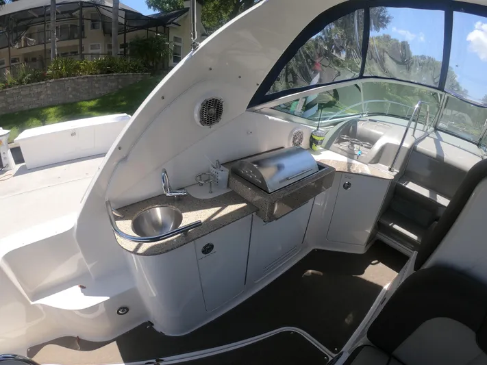 Stella Nautica Yacht Photos Pics 2015 Sea Ray 330 Sundancer boat interior with kitchenette and seating area.