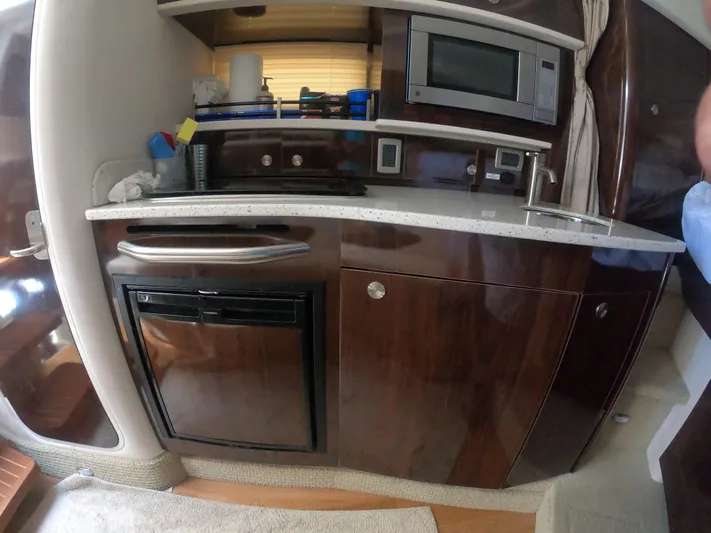 Stella Nautica Yacht Photos Pics 2015 Sea Ray 330 Sundancer interior kitchen with microwave and mini fridge.