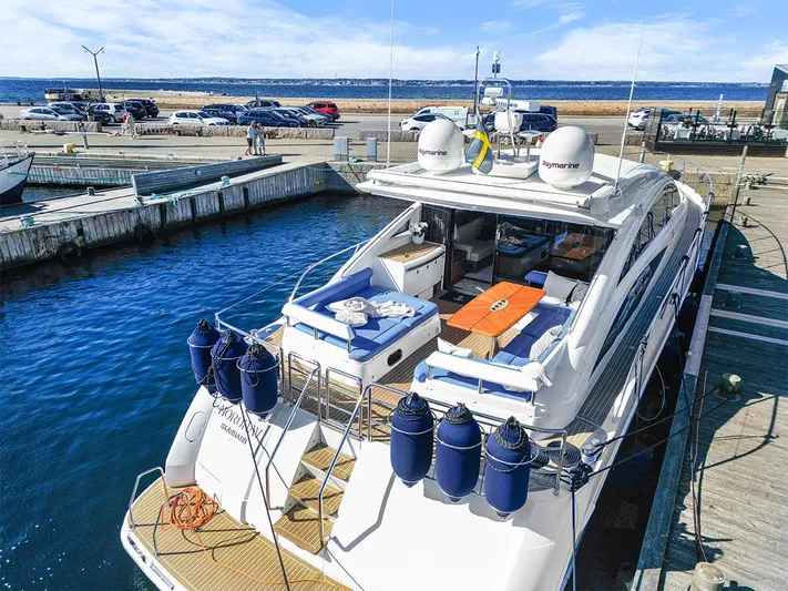  Yacht Photos Pics Luxury 2008 Princess V65 yacht docked at marina, featuring spacious deck and seating area.