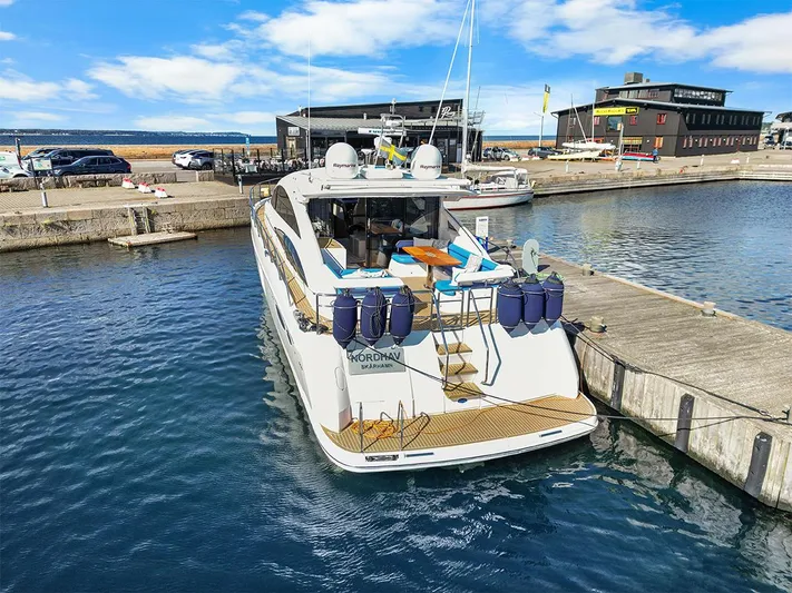  Yacht Photos Pics Luxury 2008 Princess V65 yacht docked at marina under blue sky.