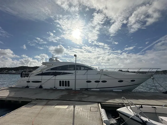  Yacht Photos Pics 2008 Princess V65 yacht docked under a partly cloudy sky.