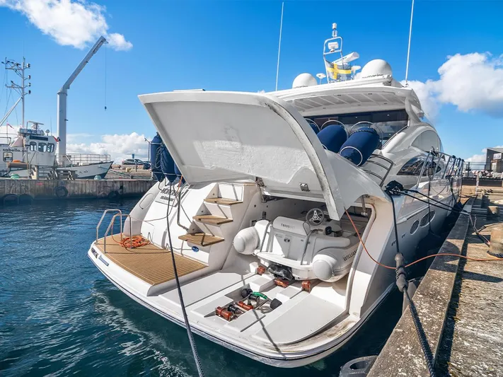  Yacht Photos Pics 2008 Princess V65 yacht docked, showcasing open stern with steps and equipment.