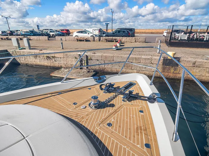  Yacht Photos Pics Bow of 2008 Princess V65 yacht docked at a marina with clear skies.