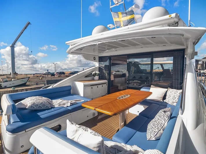  Yacht Photos Pics Luxurious 2008 Princess V65 yacht with spacious outdoor seating and elegant wooden table.