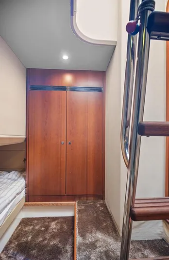  Yacht Photos Pics Interior of 2008 Princess V65 yacht with wooden cabinetry and ladder.