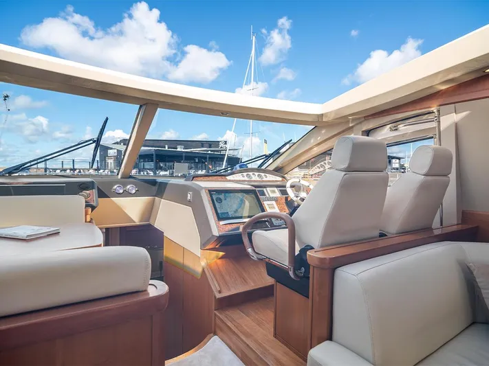  Yacht Photos Pics Luxurious interior of 2008 Princess V65 yacht with modern helm and seating.