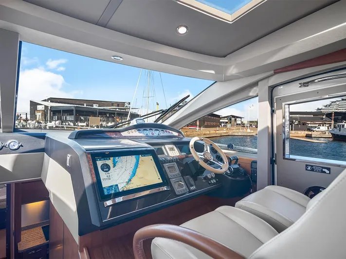  Yacht Photos Pics Luxurious 2008 Princess V65 yacht cockpit with navigation system and marina view.