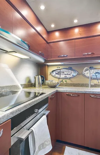  Yacht Photos Pics Luxurious kitchen interior of 2008 Princess V65 yacht with modern appliances and sleek cabinetry.