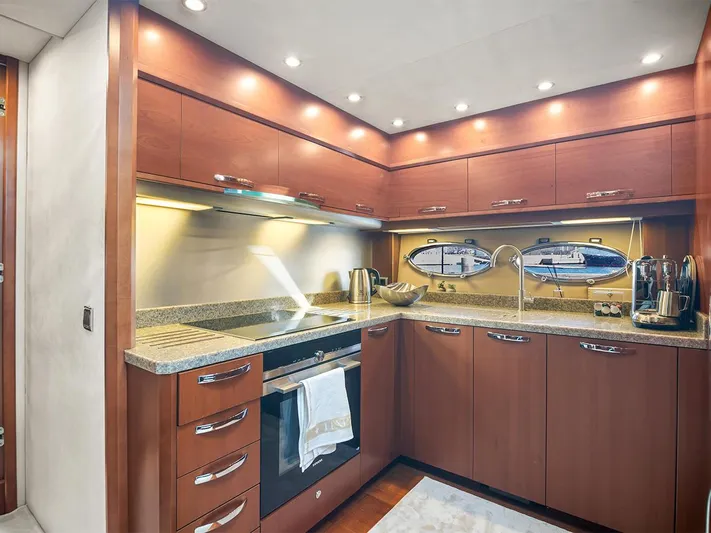  Yacht Photos Pics Luxurious kitchen interior of 2008 Princess V65 yacht with modern appliances and wood cabinetry.