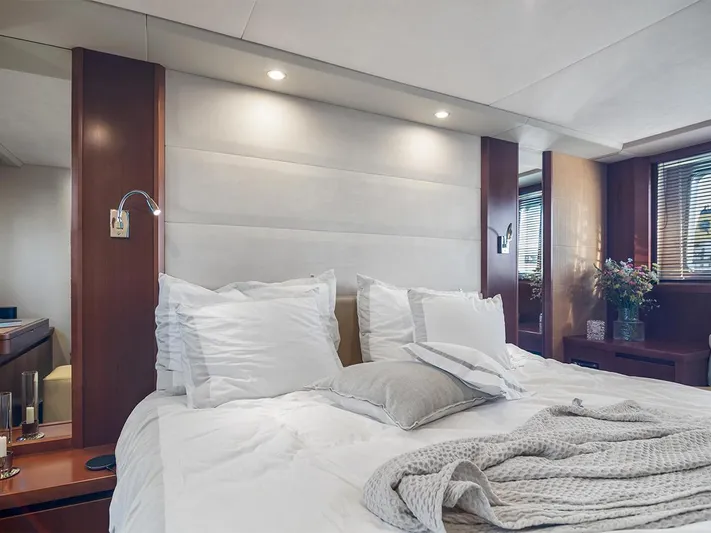  Yacht Photos Pics Luxurious bedroom interior of 2008 Princess V65 yacht with elegant bedding and ambient lighting.