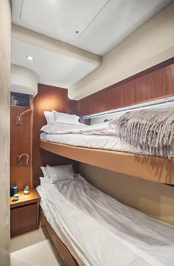  Yacht Photos Pics Cozy bunk beds in 2008 Princess V65 yacht cabin, featuring modern wood paneling.