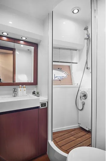  Yacht Photos Pics Luxurious bathroom in 2008 Princess V65 yacht with modern fixtures and wooden accents.