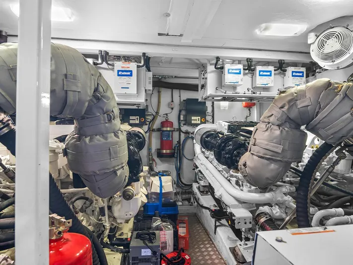  Yacht Photos Pics Engine room of a 2008 Princess V65 yacht, featuring dual engines and safety equipment.