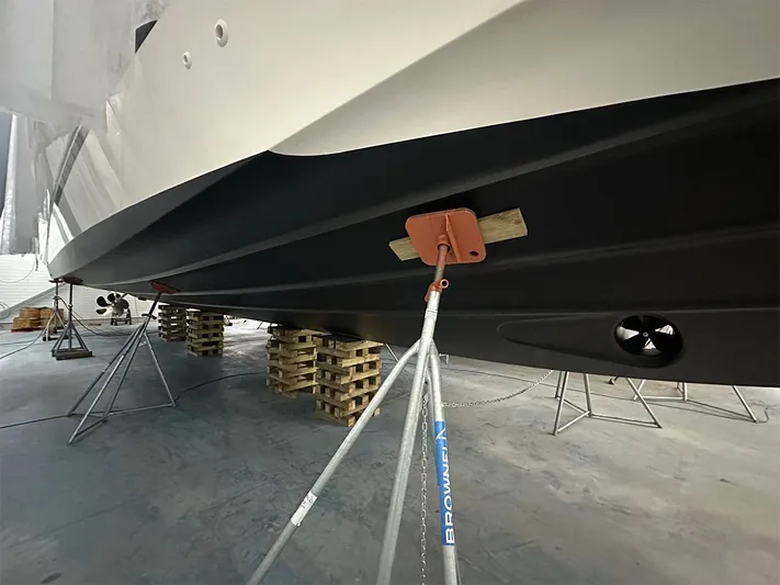  Yacht Photos Pics 2008 Princess V65 yacht hull supported on stands in a maintenance facility.