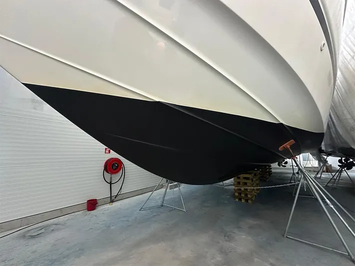  Yacht Photos Pics 2008 Princess V65 yacht hull in dry dock, showcasing sleek design and maintenance setup.