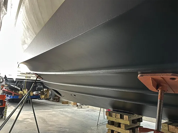  Yacht Photos Pics 2008 Princess V65 yacht hull in dry dock, supported by stands and blocks.