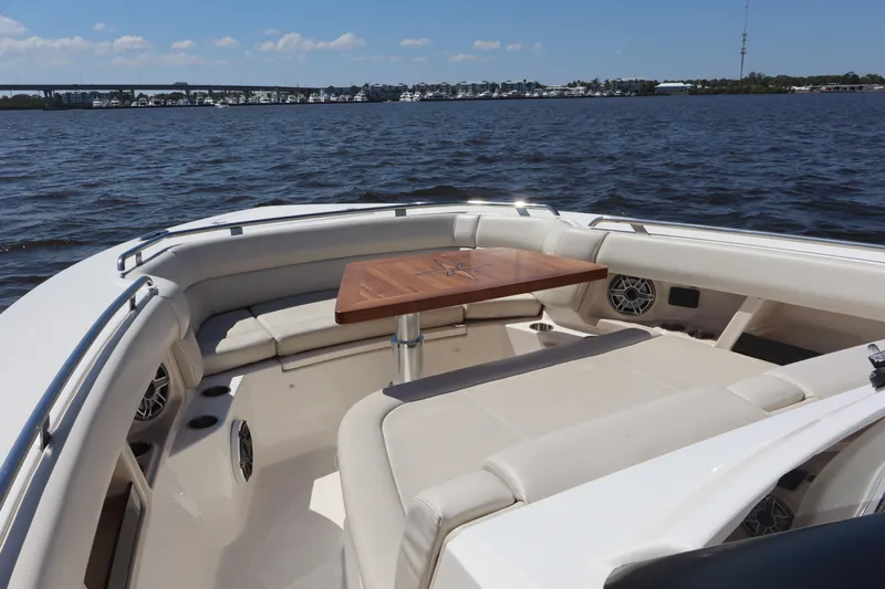  Yacht Photos Pics 2023 Boston Whaler 350 Realm boat interior with seating and table on the water.