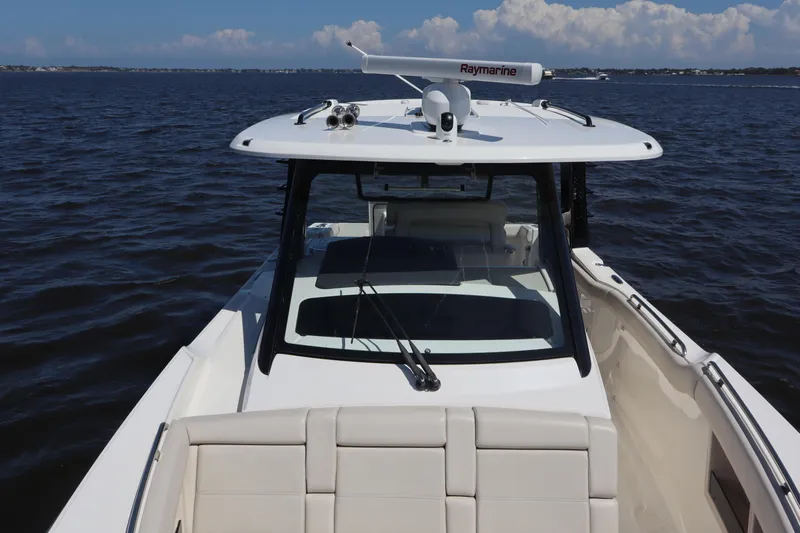  Yacht Photos Pics 2023 Boston Whaler 350 Realm boat on open water, featuring sleek design and advanced navigation equipment.