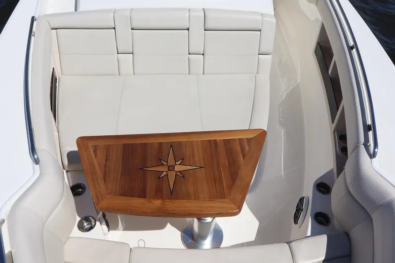  Yacht Photos Pics 2023 Boston Whaler 350 Realm interior with elegant seating and wooden table.