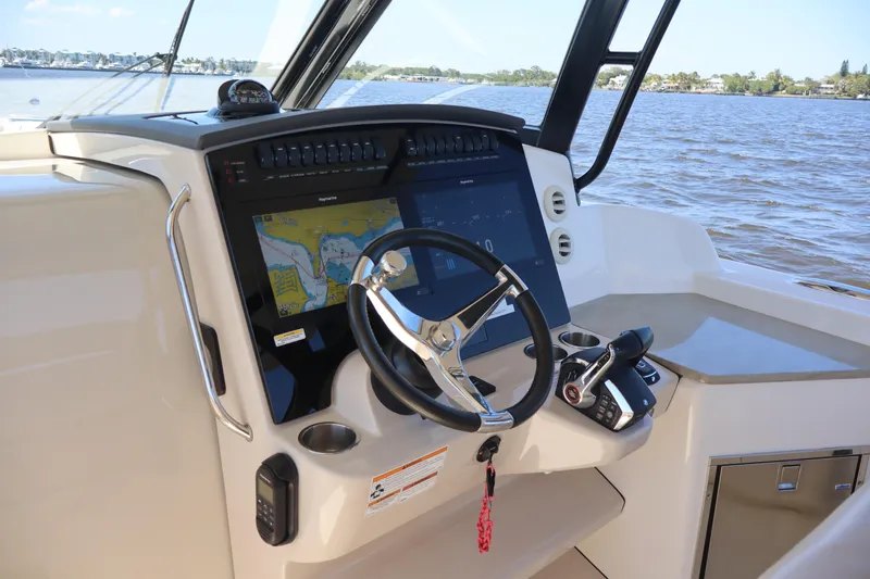  Yacht Photos Pics 2023 Boston Whaler 350 Realm helm with advanced navigation system and steering wheel.
