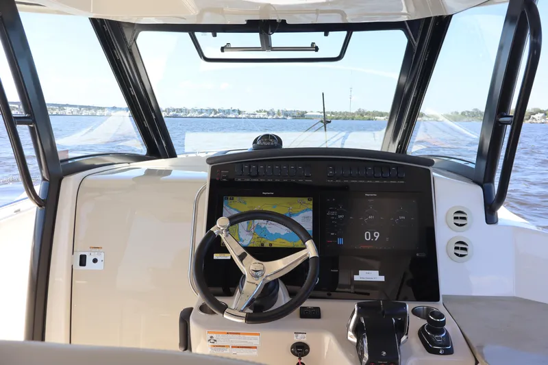  Yacht Photos Pics 2023 Boston Whaler 350 Realm helm with navigation display on open water.