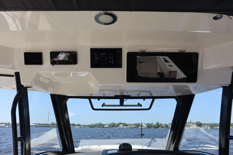  Yacht Photos Pics 2023 Boston Whaler 350 Realm helm with advanced navigation systems and panoramic water view.