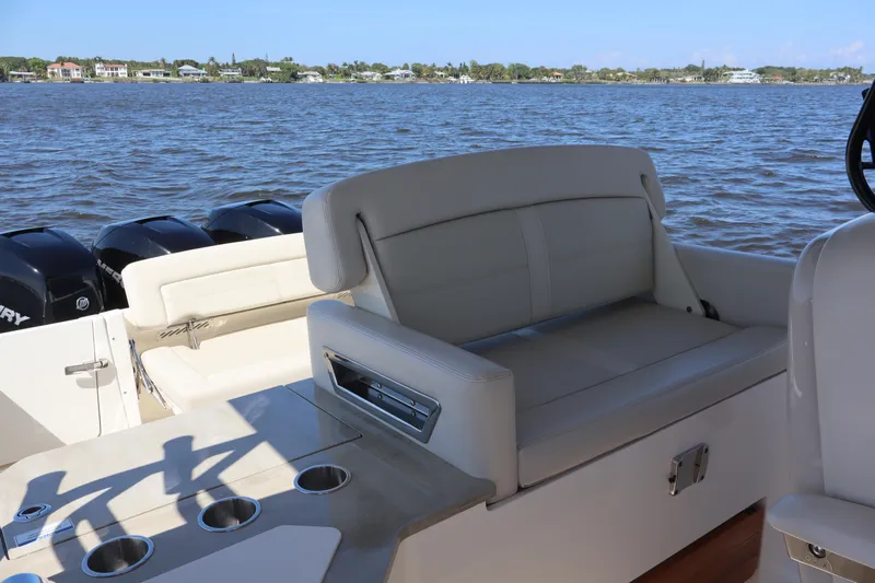  Yacht Photos Pics 2023 Boston Whaler 350 Realm boat interior with seating and ocean view.