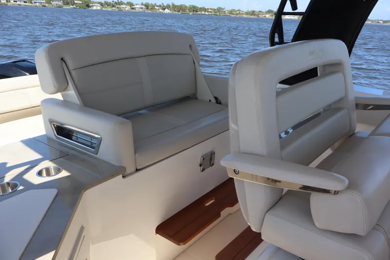  Yacht Photos Pics 2023 Boston Whaler 350 Realm interior seating with luxurious white upholstery.