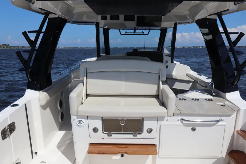 Yacht Photos Pics 2023 Boston Whaler 350 Realm boat interior with seating and ocean view.