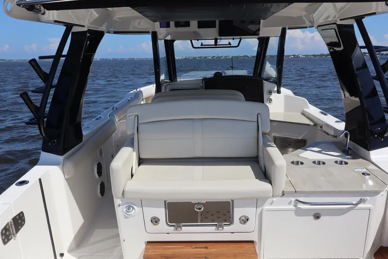  Yacht Photos Pics 2023 Boston Whaler 350 Realm interior with seating and ocean view.