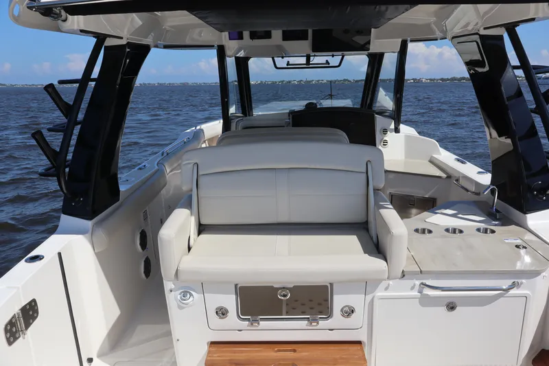  Yacht Photos Pics 2023 Boston Whaler 350 Realm interior with seating, ocean view, and sleek design.