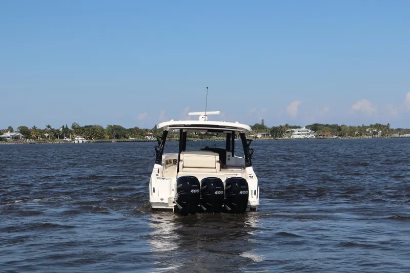  Yacht Photos Pics 2023 Boston Whaler 350 Realm boat on open water with triple engines.