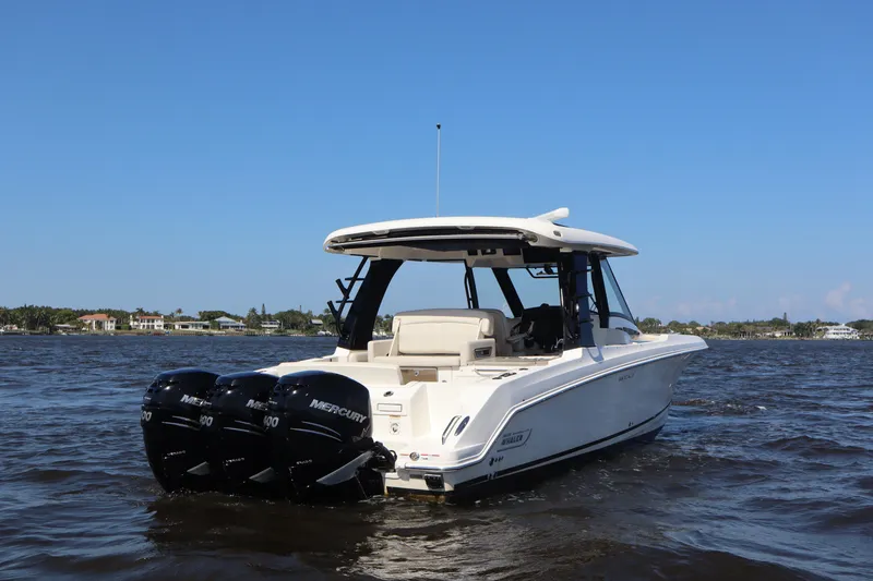  Yacht Photos Pics 2023 Boston Whaler 350 Realm boat on water with triple Mercury engines.
