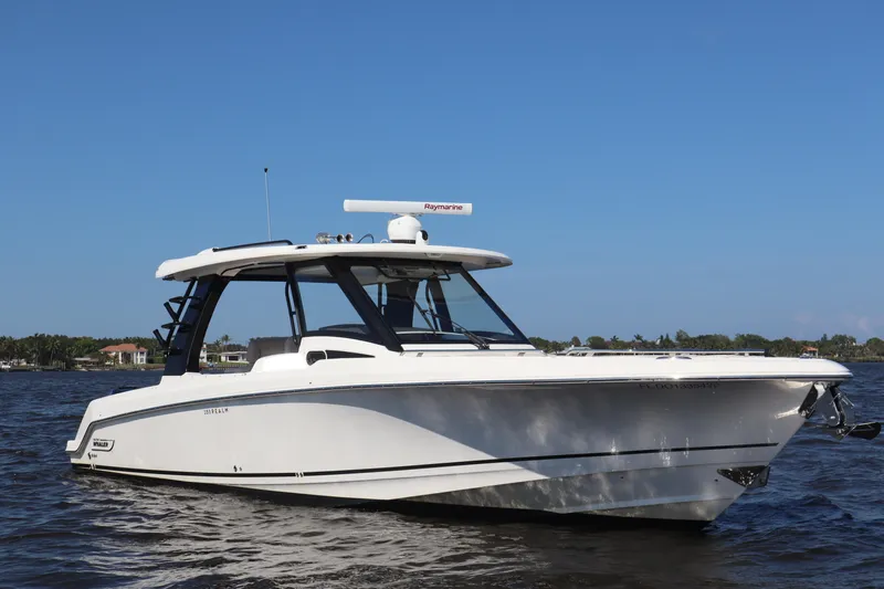  Yacht Photos Pics 2023 Boston Whaler 350 Realm boat on water under clear blue sky.