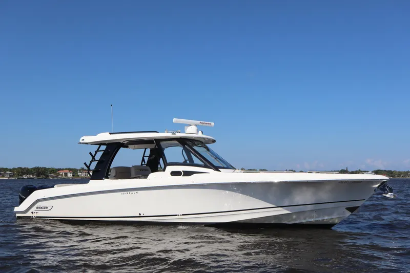  Yacht Photos Pics 2023 Boston Whaler 350 Realm boat on water under clear blue sky.