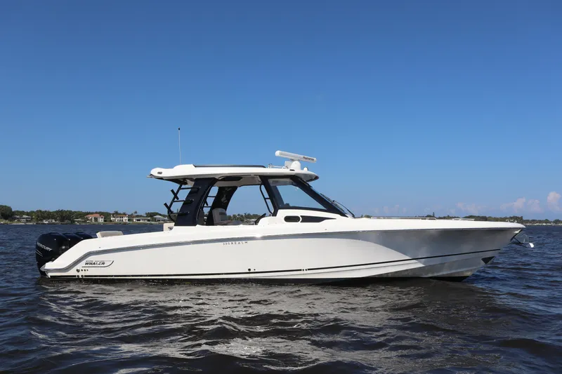  Yacht Photos Pics 2023 Boston Whaler 350 Realm boat on water under clear blue sky.