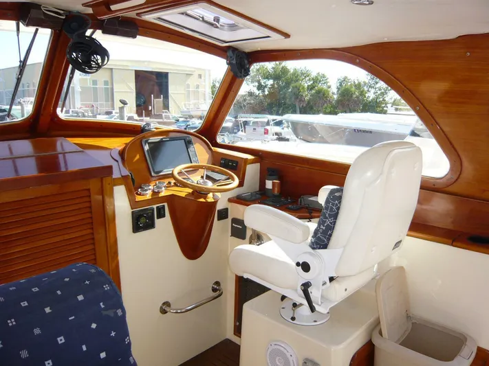 Courage Yacht Photos Pics Interior of 1998 Hinckley 36 Classic boat with wooden dashboard and captain's chair.