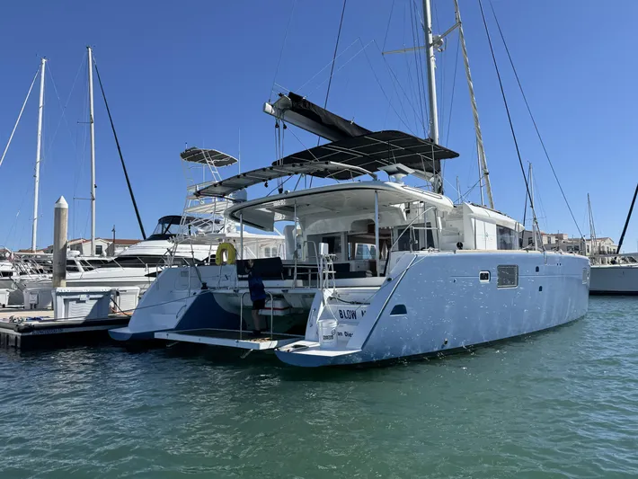  Yacht Photos Pics 2017 Lagoon 450 F catamaran docked in marina, clear blue sky, calm water.