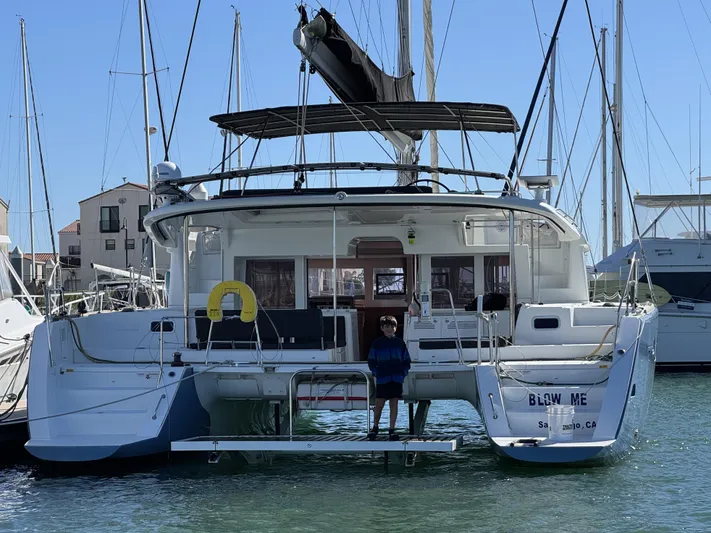  Yacht Photos Pics 2017 Lagoon 450 F catamaran docked at a marina, rear view.