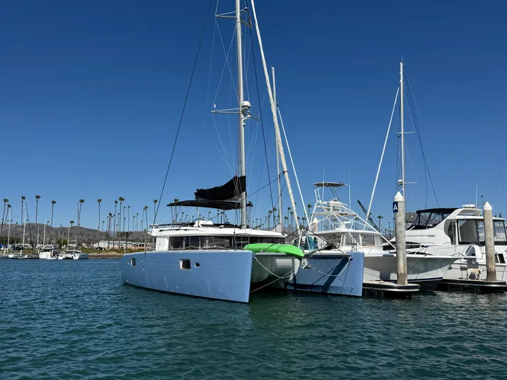  Yacht Photos Pics 2017 Lagoon 450 F catamaran docked in a marina under clear blue skies.