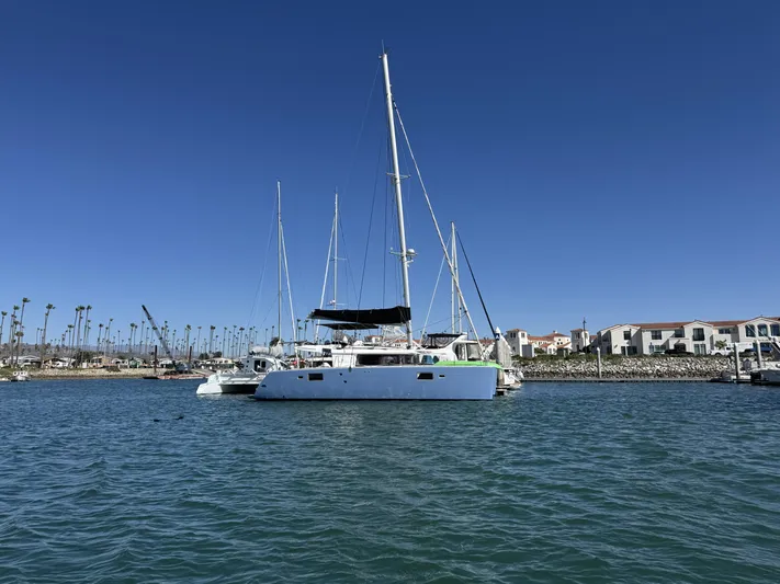  Yacht Photos Pics 2017 Lagoon 450 F catamaran docked in a sunny marina with clear blue skies.