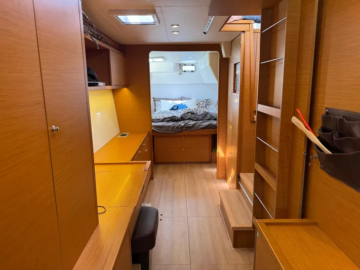  Yacht Photos Pics Interior of 2017 Lagoon 450 F catamaran, featuring a cozy cabin with wooden furnishings.