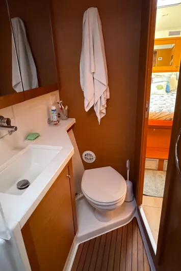  Yacht Photos Pics 2017 Lagoon 450 F yacht bathroom with sink, toilet, and wooden flooring.