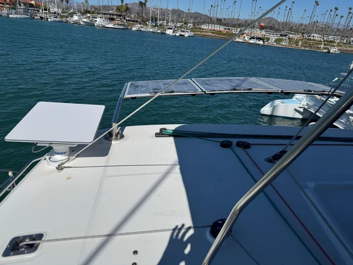  Yacht Photos Pics 2017 Lagoon 450 F catamaran deck with solar panels, docked in a marina.